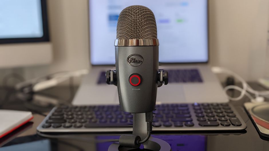 Broadcast dynamic studio microphone positioned on an articulated boom arm in an acoustically treated room
