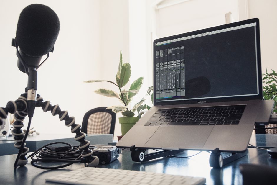 Close-up of camera lens calibration and desk-mounted monitor setup for online interviews