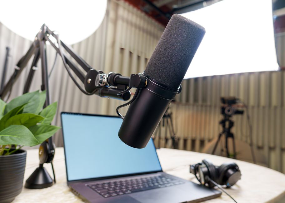 Audio recording workstation with hardware mixer, studio monitors, and digital audio workstation software